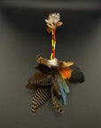 A long decorative feather and bead hair clip by Huni Kuin artisans