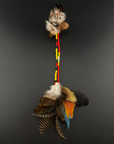 A long decorative feather and bead hair clip by Huni Kuin artisans