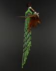 A South American style beaded feather ornament featuring bright green, black, and white beads, a brown wooden shaft, and brown feathers, displayed against a dark gray background.