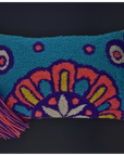 A turquoise blue hook-and-loop pouch with a colorful mandala pattern in orange, purple, yellow, and white, featuring a red pom-pom and tassel zipper pull on a black background.