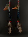 Pair of earrings with beads and feathers on a black background