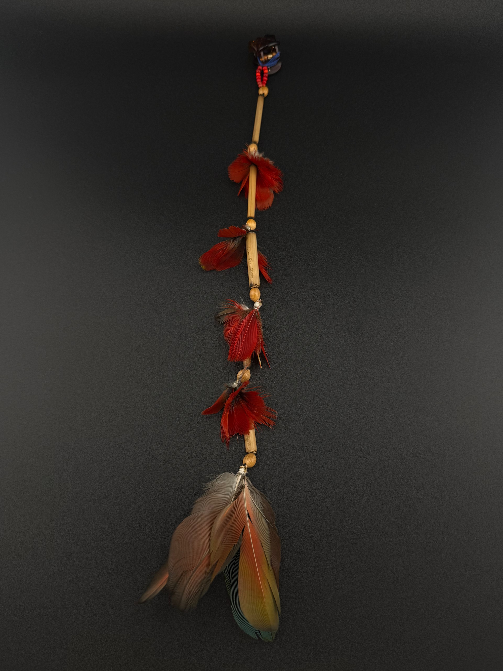 A long decorative feather and bead hair clip by Huni Kuin artisans 